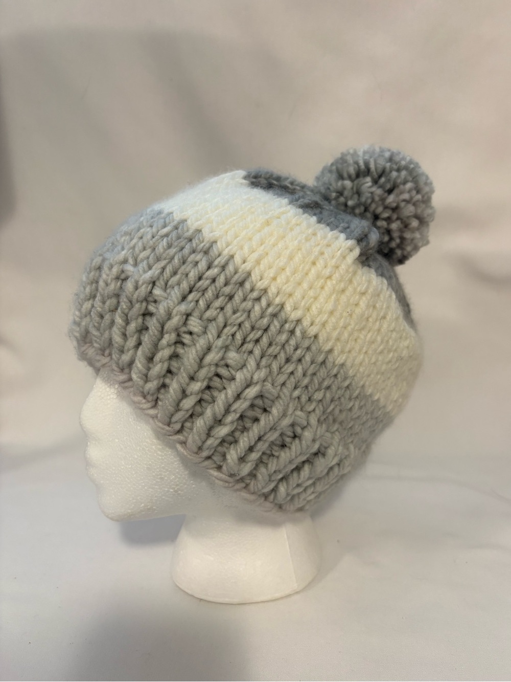 Gray and white knitted toque/hat